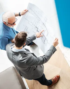 two people looking at a blueprint